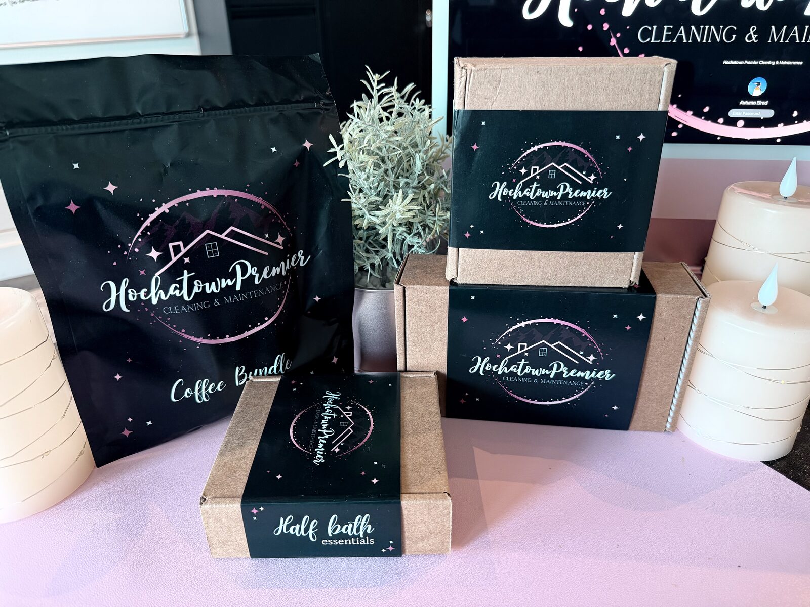 Hochatown Premier guest bundle lineup — a Coffee Bundle pouch, a Half Bath Essentials box and branded boxes with candles on a styled table
